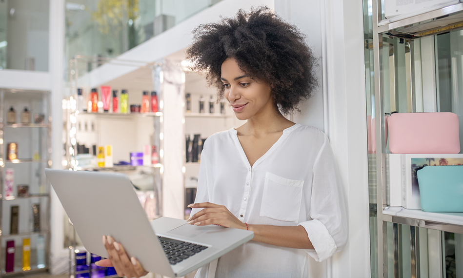 Woman using laptop in hair salon
