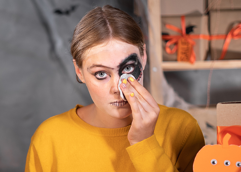 woman removing halloween face makeup